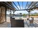 Inviting outdoor lounge area with comfortable seating and pergola, offering serene waterfront views at 9920 Spoonbill E Rd, Bradenton, FL 34209