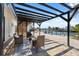 Relaxing outdoor patio with a pergola, waterfront views, and comfortable seating area at 9920 Spoonbill E Rd, Bradenton, FL 34209
