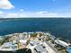 A wide aerial shot displaying waterfront homes with docks and boat lifts and calm waters reaching to the distant horizon at 9920 Spoonbill E Rd, Bradenton, FL 34209