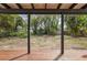 A large backyard with a covered patio and lush greenery, offering privacy and shade at 108 5Th St, Belleair Beach, FL 33786