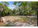 Large backyard offers ample space surrounded by lush trees, shrubs, and partial fencing at 108 5Th St, Belleair Beach, FL 33786