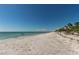 Wide sandy beach with calm turquoise waters and a clear blue sky at 108 5Th St, Belleair Beach, FL 33786