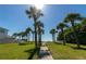 Scenic pathway to the beach lined with palm trees and lush greenery on a sunny day at 108 5Th St, Belleair Beach, FL 33786