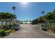 Beach access entrance featuring palm trees and glimpses of the serene ocean at 108 5Th St, Belleair Beach, FL 33786