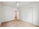 Well-lit bedroom with light hardwood floors, white walls and trim, ceiling fan, and modern features at 108 5Th St, Belleair Beach, FL 33786