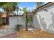 Charming home exterior with a gravel and brick walkway and a side entry door at 108 5Th St, Belleair Beach, FL 33786
