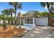 Lovely home with well-maintained landscaping, palm trees, stone accents, and an attached garage, ready to welcome you at 108 5Th St, Belleair Beach, FL 33786