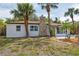 Inviting single-story home with well-maintained landscaping and a stone chimney at 108 5Th St, Belleair Beach, FL 33786