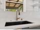 Close-up of the kitchen sink with white counters, subway tile backsplash and modern faucet at 108 5Th St, Belleair Beach, FL 33786