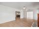 Open concept living room featuring hardwood floors, white walls, and a view to the kitchen at 108 5Th St, Belleair Beach, FL 33786