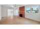 Bright living room featuring hardwood floors, a decorative fireplace, and natural light at 108 5Th St, Belleair Beach, FL 33786