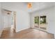 Bright living room features wood floors and sliding glass doors to the outdoor area at 108 5Th St, Belleair Beach, FL 33786