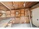 An unfinished workshop area with wooden walls, built-in shelves, and a sturdy workbench for all your projects at 108 5Th St, Belleair Beach, FL 33786