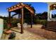 Cozy backyard with brick pavers, a pergola with cafe lights, and a white outdoor dining set at 108 Bermuda Ave, Tampa, FL 33606