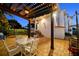 Beautiful backyard with a pergola, outdoor seating, and meticulous landscaping and a brick paver patio at 108 Bermuda Ave, Tampa, FL 33606