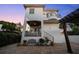 Backyard with brick pavers, lounge area, wrought iron staircase, balcony, and lush landscaping at 108 Bermuda Ave, Tampa, FL 33606