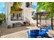 Beautiful home featuring a brick patio, a pergola, lush palm trees, and comfortable outdoor seating at 108 Bermuda Ave, Tampa, FL 33606
