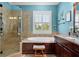 Bathroom featuring tile surround shower, soaking tub, granite countertop and plantation shutters at 108 Bermuda Ave, Tampa, FL 33606