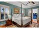 Traditional primary bedroom with a balcony, a four-poster bed and decorative touches at 108 Bermuda Ave, Tampa, FL 33606
