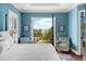 Relaxing bedroom view to the neighborhood via a balcony with patio chairs at 108 Bermuda Ave, Tampa, FL 33606