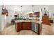 Open kitchen with a large island, stainless steel dishwasher, and a view of the living area at 108 Bermuda Ave, Tampa, FL 33606