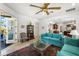 Cozy living room featuring turquoise sofas, ceiling fan, and access to the outdoor balcony at 108 Bermuda Ave, Tampa, FL 33606