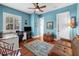 Blue office space with hardwood floors, a ceiling fan, and a leather sofa at 108 Bermuda Ave, Tampa, FL 33606