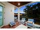 Relaxing outdoor lounge area with brick floors, comfortable seating and views of mature landscaping at 108 Bermuda Ave, Tampa, FL 33606