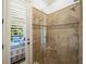 Detailed shot of the tiled shower with a glass door, showcasing quality craftsmanship and modern design elements at 108 Bermuda Ave, Tampa, FL 33606