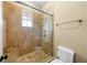 Tiled shower stall with a glass door and bronze fixtures at 108 Bermuda Ave, Tampa, FL 33606