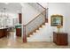 Beautiful staircase with wood and iron railing, with views into the dining room and living room at 108 Bermuda Ave, Tampa, FL 33606