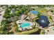 Wide aerial view of the pool, clubhouse, playground, tennis courts, and pond in a Gathering-friendly neighborhood at 10922 Holly Cone Dr, Riverview, FL 33569
