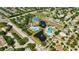 Expansive aerial view of community amenities, including pools, tennis courts, playground, and scenic ponds at 10922 Holly Cone Dr, Riverview, FL 33569