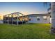 A spacious backyard with a well-maintained lawn and a cozy screened-in patio at 10922 Holly Cone Dr, Riverview, FL 33569
