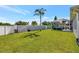 Large backyard featuring a privacy fence and screened-in patio with a hot tub at 10922 Holly Cone Dr, Riverview, FL 33569