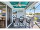 The covered outdoor bar offers seating for four, a TV, and easy access through sliding glass doors at 10922 Holly Cone Dr, Riverview, FL 33569