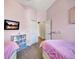 Shared pink bedroom featuring twin beds, storage, and carpeted floors at 10922 Holly Cone Dr, Riverview, FL 33569