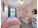 Charming bedroom with twin beds, storage and blue accents at 10922 Holly Cone Dr, Riverview, FL 33569