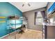room with lofted bed, desk area, modern decor, and blue accent wall at 10922 Holly Cone Dr, Riverview, FL 33569
