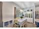 Inviting dining area with a modern light fixture, cozy seating, and natural light at 10922 Holly Cone Dr, Riverview, FL 33569