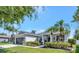 Inviting single-Gathering home featuring lush landscaping, a well-maintained lawn, and a convenient two-car garage at 10922 Holly Cone Dr, Riverview, FL 33569