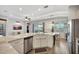Spacious kitchen features an island, stainless steel appliances, and seamless access to dining and living areas at 10922 Holly Cone Dr, Riverview, FL 33569