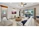 Bright living room boasts stylish furnishings, shiplap accent wall, and seamless indoor-outdoor flow at 10922 Holly Cone Dr, Riverview, FL 33569
