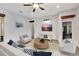 Bright living room featuring a ceiling fan, white shiplap accent wall with TV, and neutral furniture at 10922 Holly Cone Dr, Riverview, FL 33569
