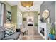 Comfortable living room with fireplace, wood floors, neutral color scheme and access to other rooms in the house at 10922 Holly Cone Dr, Riverview, FL 33569