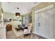 Cozy living room with stylish decor, including wood floors, modern lighting, and comfortable seating at 10922 Holly Cone Dr, Riverview, FL 33569