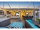 The covered outdoor patio offers multiple seating areas, a bar, a spa, and outdoor TVs for entertainment at 10922 Holly Cone Dr, Riverview, FL 33569
