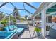 Relaxing screened-in patio featuring a jacuzzi, outdoor seating, and view to the backyard at 10922 Holly Cone Dr, Riverview, FL 33569