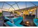The covered outdoor patio is complete with an outdoor kitchen, dining area, hot tub and seating areas at 10922 Holly Cone Dr, Riverview, FL 33569