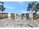 A covered outdoor patio area with a pergola, fire pit, and ample seating at 10922 Holly Cone Dr, Riverview, FL 33569